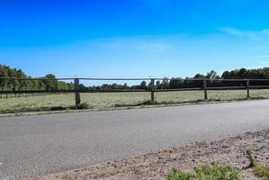 Beautiful wooden horse fence at an agricultural field photo