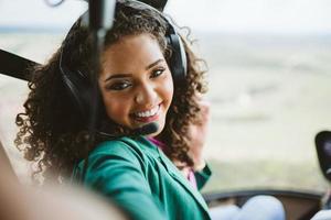 Successful smart stylish young latin woman in the helicopter. Luxury lifestyle concept