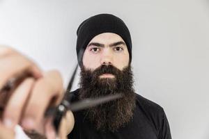 barber with long beard using scissors photo