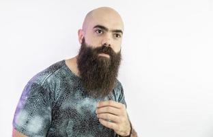 Bearded man looking at the camera. Concept of masculinity and care with the beard. Pointing with finger, approving or indicating. photo