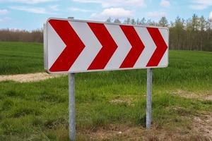 A large warning sign for a very sharp bend on a German country road photo
