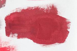Concept of a paintbrush on a piece of paper with brush strokes in red and brown photo
