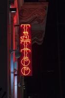 Paris, France - May 01 2019 - Red tattoo neon light sign photo