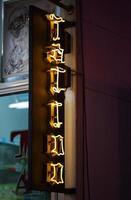 Pattaya, Thailand - September 23 2013 - Yellow tattoo neon light sign photo