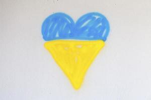 Spray painted Ukrainian flag shaped into a heart photo