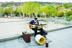 Georgia, Tbilisi, 2022-Street musician play live music for tourist photo