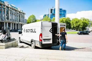 Tbilisi, Georgia, 2022-Man collecting Scroll scooter to charge photo