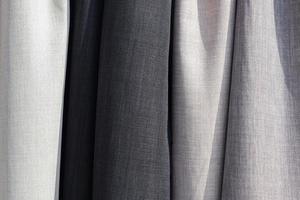 Samples of cloth and fabrics in different colors found at a fabrics market. photo