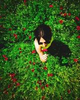 Young Caucasian woman pick poppy flower and smell outdoors. Concept freedom spring being in nature healthy lifestyle. photo