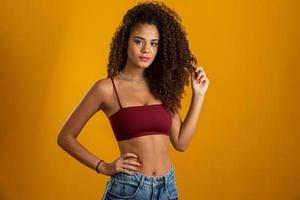 Beautiful african american girl with an afro hairstyle smiling. Beauty portrait of african american woman with afro hairstyle and glamour makeup. Brazilian young woman. photo