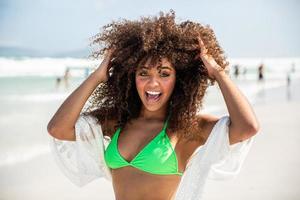 Black afro young cute girl, curly hair, bikini, beach. Afro American summer vacation holiday. photo