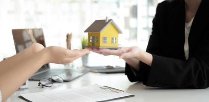 Real estate company to buy houses and land are delivering keys and houses to customers after agreeing to make a home purchase agreement and make a loan agreement. Discussion with a real estate agent photo