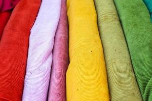 Samples of cloth and fabrics in different colors found at a fabrics market. photo