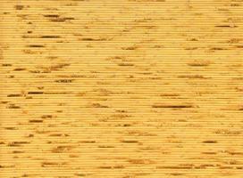 background and texture of decorative yellow bamboo wood on finishing wall surface. bamboo line making from fire burn. photo