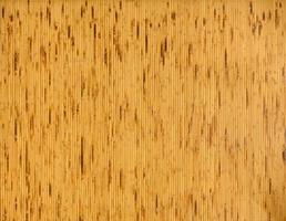 background and texture of decorative yellow bamboo wood on finishing wall surface. bamboo line making from fire burn. photo