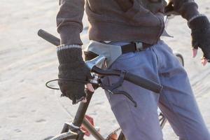 Alone rider on fixed gear road bike riding in the desert near river, hipster tourist bicycle rider pictures. photo