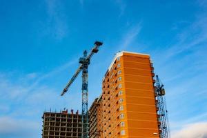 Concrete building in progress with cranes photo