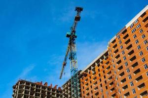 Concrete building in progress with cranes photo