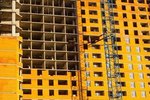 Concrete building in progress with cranes photo