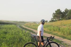 joven atleta montando en su bicicleta profesional de montaña o ciclocross en el bosque foto