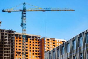 Concrete building in progress with cranes photo