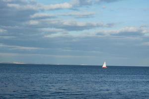 minimalistic landscape with sailing boat photo