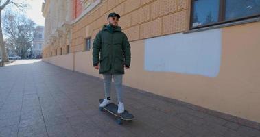 Young male ride on longboard skate on the streets photo