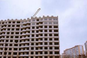 Concrete building in progress with cranes photo