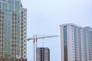 Concrete building in progress with cranes photo