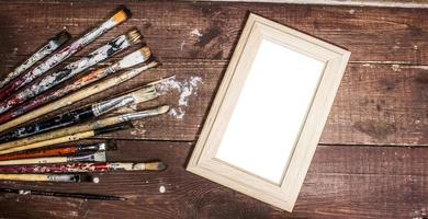 Blank photo frame with paint brushes decoration