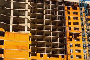 Concrete building in progress with cranes photo