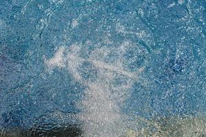 Air bubbles and rippled water in swimming pool photo