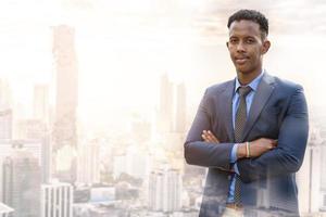 Business people in city. Portrait of an handsome businessman. Modern businessman. Confident young man in full suit and glasses while standing outdoors looking away with cityscape in the background photo