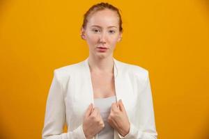 Young, confident, successful and beautiful business redhead woman on yellow. Occupation, career, job concept. photo