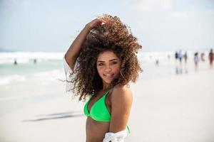 Black afro young cute girl, curly hair, bikini, beach. Afro American summer vacation holiday. photo