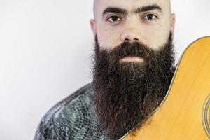 Bearded musician with his guitar photo