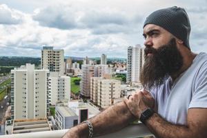 Bearded man looking the horizon. Concept of masculinity and care with the beard. photo