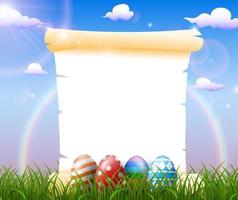 Blank paper in the grass field with decorated Easter eggs