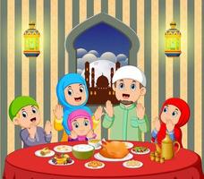 A happy family are praying before eating in their house with beautiful view from the window vector