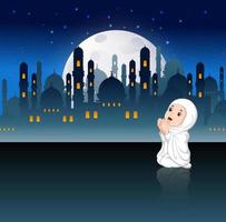 the cute girl with the white cloth are praying in the night of Ramadan