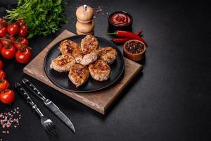 Delicious fresh fried minced meat patties on a dark concrete background photo