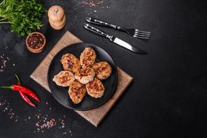 Delicious fresh fried minced meat patties on a dark concrete background photo