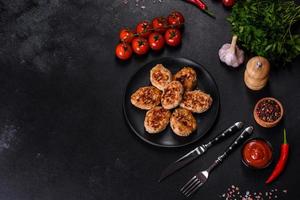 Delicious fresh fried minced meat patties on a dark concrete background photo