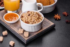 Delicious nutritious healthy breakfast with granola, eggs, oat cookies, milk and jam photo