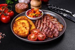 Slices of delicious grilled bacon with croutons fried in egg with spices, salt, vegetables and herbs photo