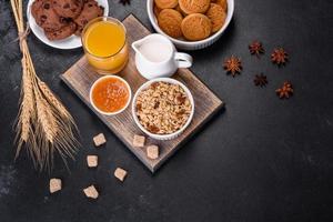 Delicious nutritious healthy breakfast with granola, eggs, oat cookies, milk and jam photo