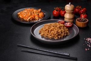 Thai noodle and chicken plate on a black concrete background with Chinese chopsticks and copy space photo