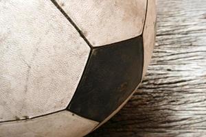 Old Soccer football on old vintage wood table photo