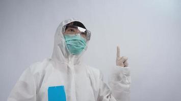 Doctor in PPE suit gesture make hand sign. Represent victory win over virus. photo