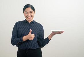 Asian woman with empty plate on hand photo